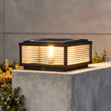 Solar outdoor pillar light glowing warm white at night