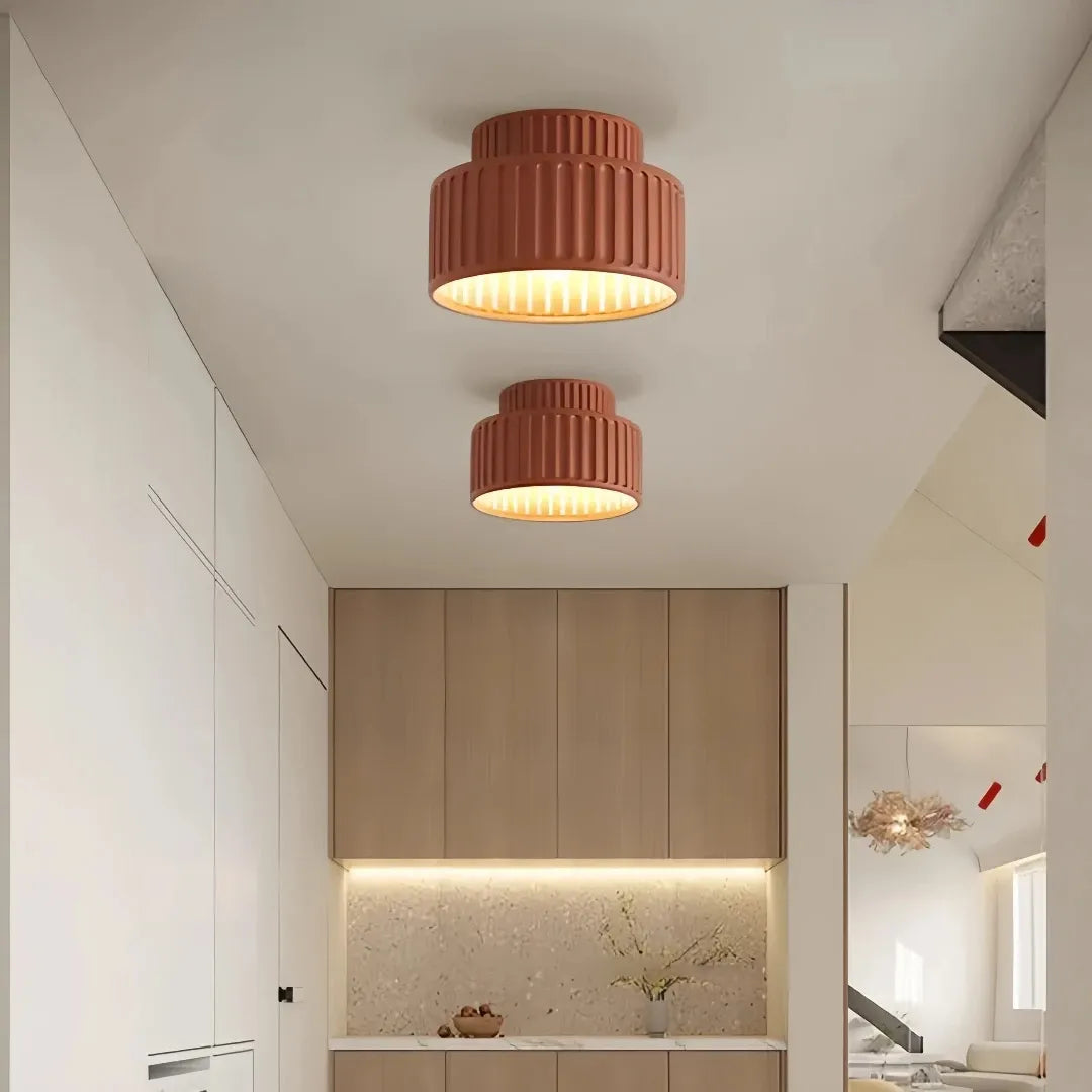 Cream ribbed ceiling light producing warm white light