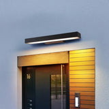 Illuminated black rectangular wall light at an exterior entrance