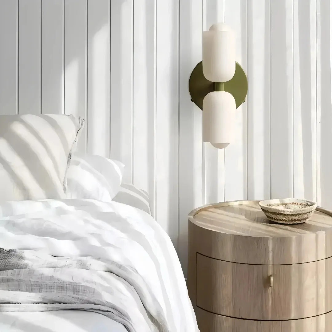 Opal glass wall light installed beside a bed in a bedroom 