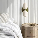 Opal glass wall light installed beside a bed in a bedroom 