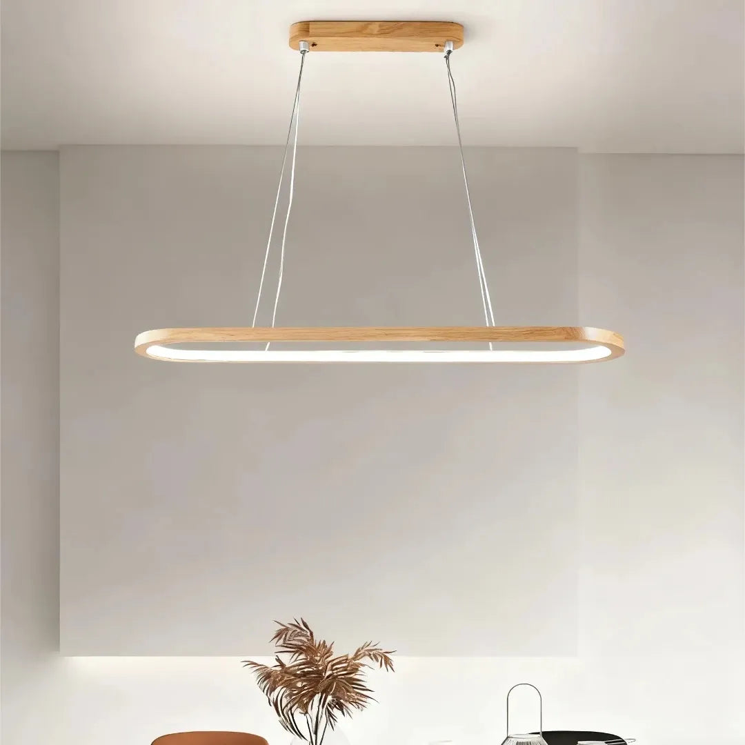 Front view of a light wood oval pendant suspended from a matching ceiling canopy