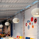 Rattan pendant light hanging above an outdoor dining table