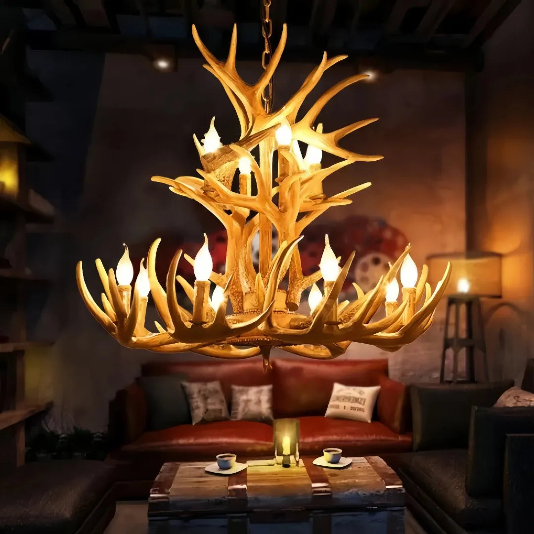 Brown faux antler chandelier lit above a coffee table