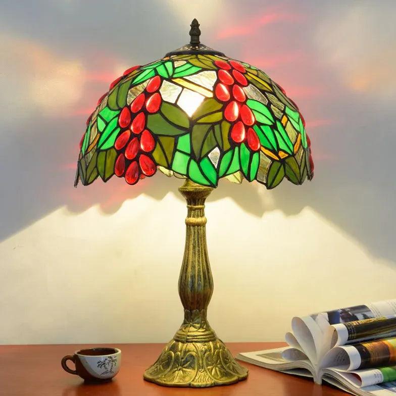 Colourful glass table light with dome silhouette