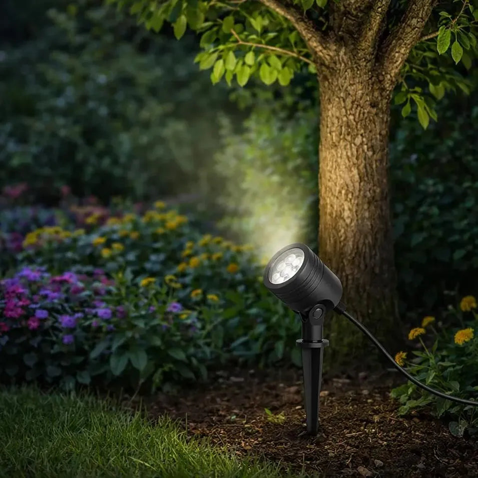 Focused garden spotlight aimed at a trunk to keep surrounding air darker