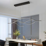 Black wave LED pendant light in a dining room