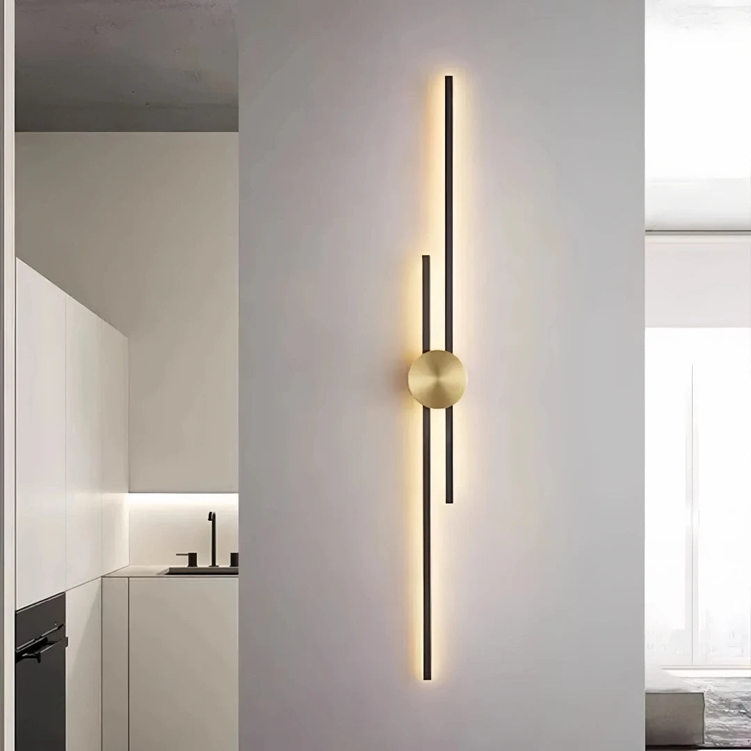 Black two-line linear LED wall light with a gold circular centre mount