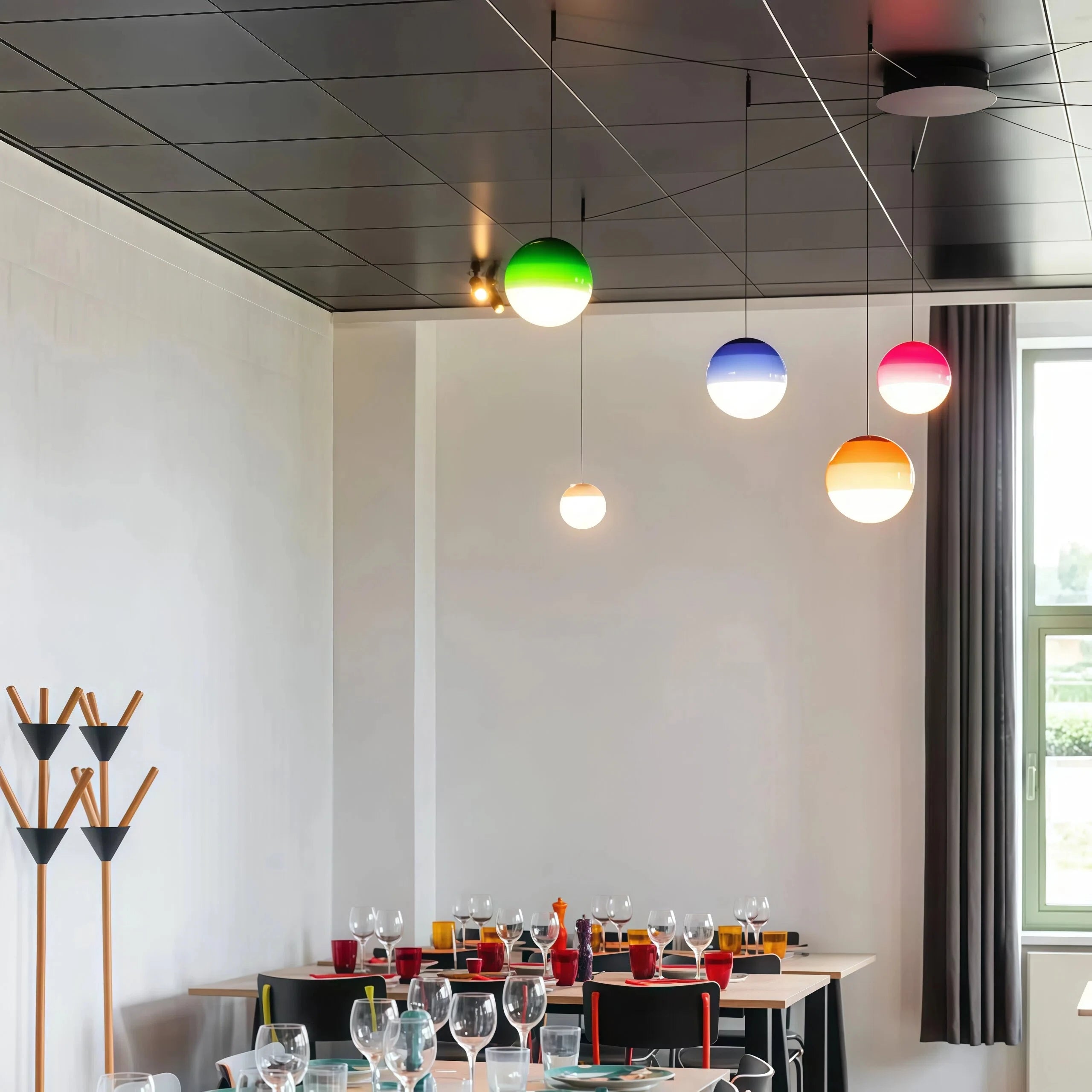 coloured glass globe pendant lights creating a gentle glow above a dining table